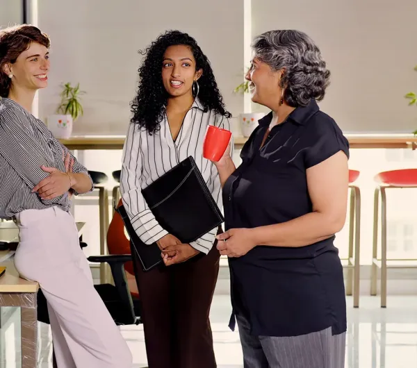 School staff in conversation over coffee