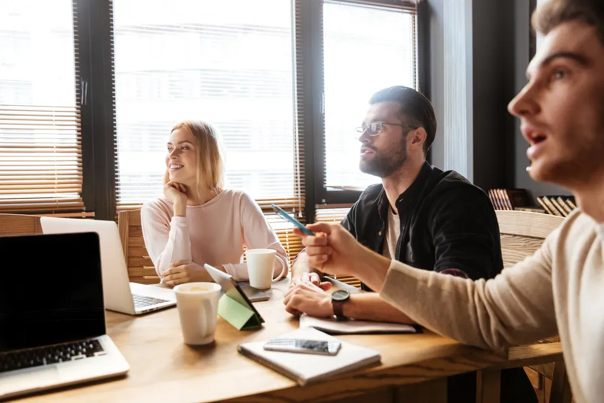 Cheerful Young Colleagues Sitting Office